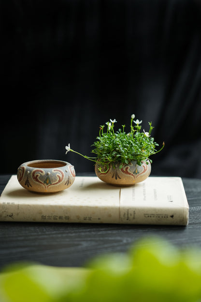 Small flower vessel shown in two styling arrangements; one vessel included