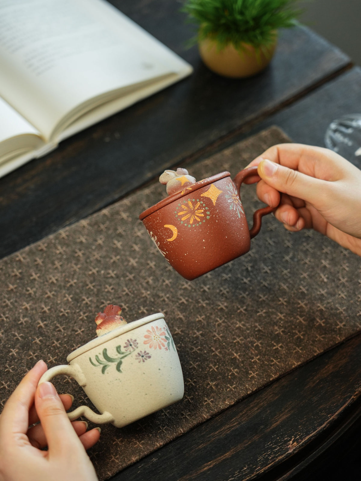 White and red clay Niu Ma lidded cups; each sold separately