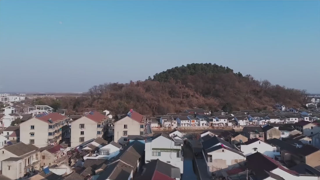 Scenes of Yixing, clay preparation, teapot craftsmanship, and local cultural landmarks.