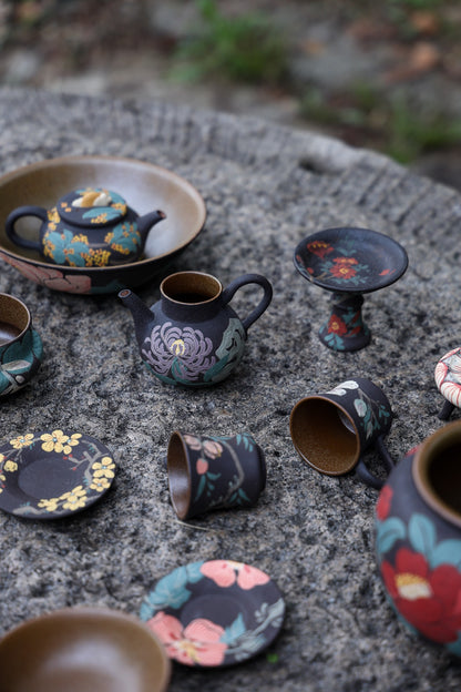 Floral tea set arranged on a stone table