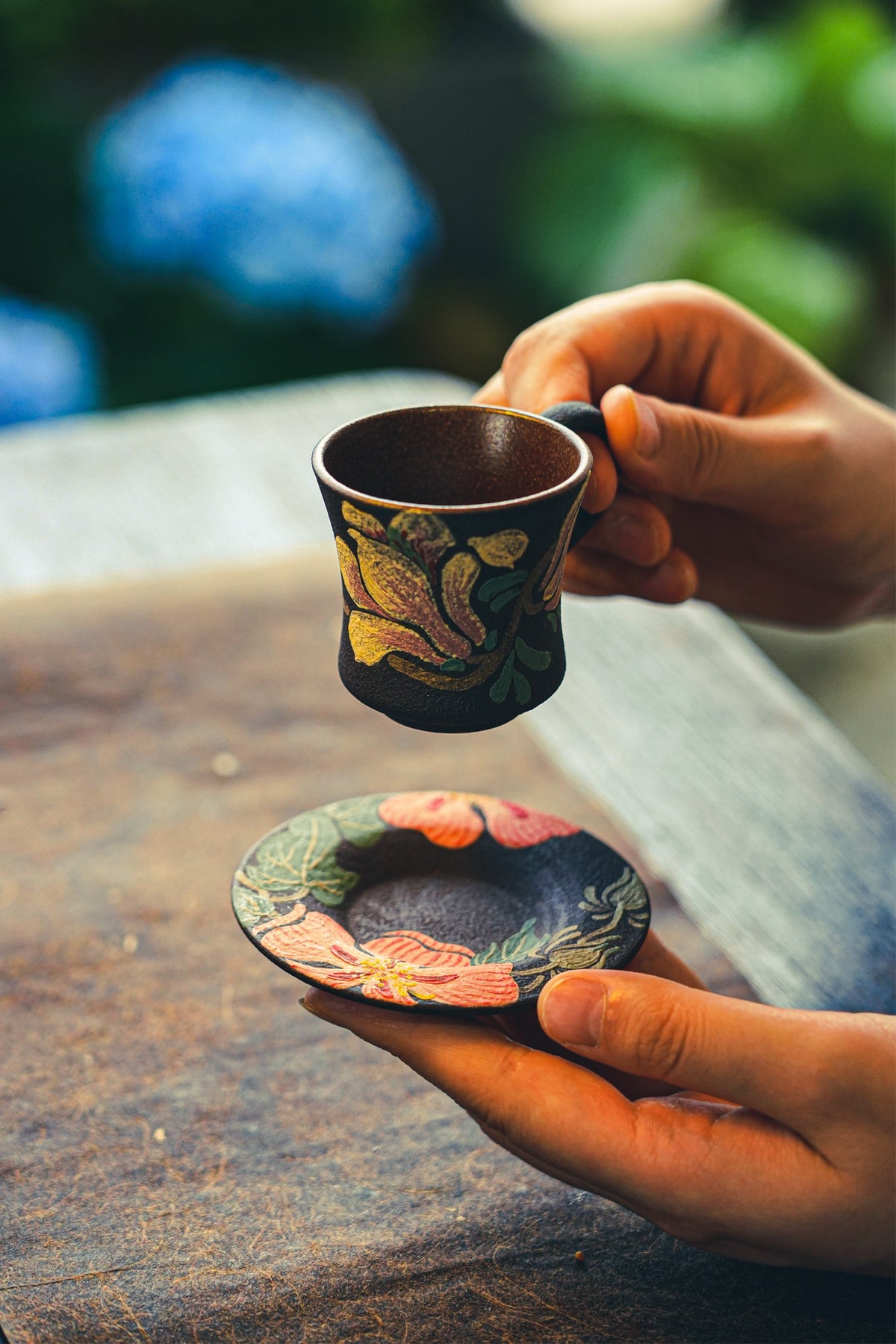 Yellow floral handled cup with floral saucer