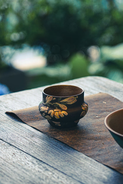 Handleless floral tea cup on a table