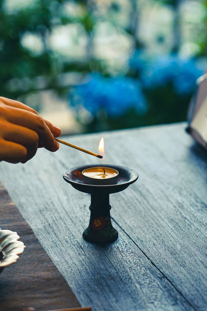 Floral candleholder styled with a tea light